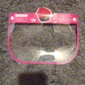 A pink face shield with a cupcake on it